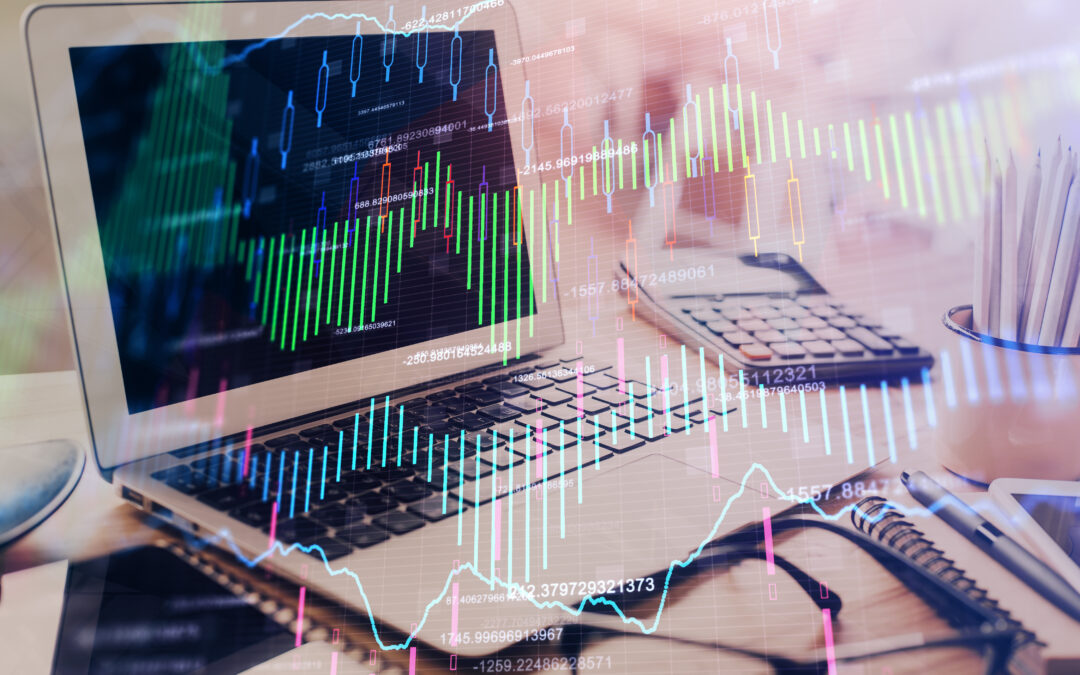 stock market graphs on top of an image of a computer at a desk