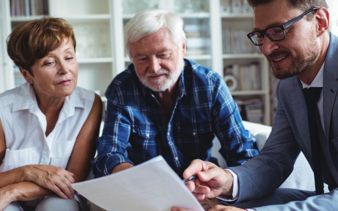 financial planner meeting with older couple to talk about finances