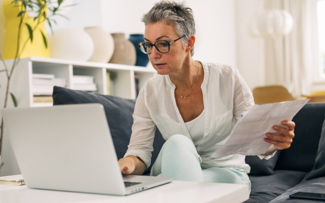Elderly woman doing taxes at home